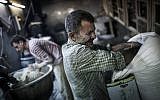 Men make bread at a bakery in the old city of Aleppo (photo credit: Andoni Lubaki/AP)