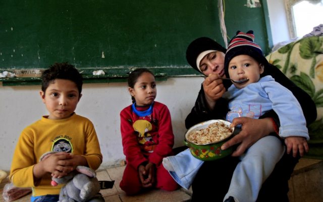 A Palestinian woman, who fled her home in the Yarmouk camp for Palestinian refugees in south Damascus, feeds her baby inside a school, at the Ein el-Hilweh refugee camp, in the southern port city of Sidon, Lebanon, on January 15, 2013. (photo credit: AP Photo/Mohammed Zaatari) A Palestinian woman, who fled her home in the Yarmouk camp for Palestinian refugees in south Damascus, feeds her baby inside a school, at the Ein el-Hilweh refugee camp, in the southern port city of Sidon, Lebanon, on January 15, 2013. (photo credit: AP Photo/Mohammed Zaatari)