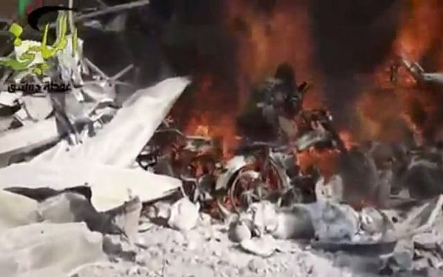 This image taken from video provided by Shaam News Network, which has been authenticated based on its contents and other AP reporting, shows a fire burning at the site of a Syrian government airstrike on a gas station in the eastern Damascus suburb of Mleiha, Syria, on Wednesday, January 2, 2013. (photo credit: AP Photo/Shaam News Network via AP video) This image taken from video provided by Shaam News Network, which has been authenticated based on its contents and other AP reporting, shows a fire burning at the site of a Syrian government airstrike on a gas station in the eastern Damascus suburb of Mleiha, Syria, on Wednesday, January 2, 2013. (photo credit: AP Photo/Shaam News Network via AP video)