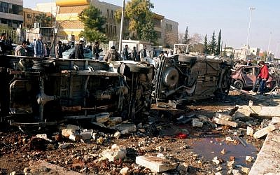 In this photo released by the Syrian official news agency SANA, Syrian people gather at the site after an explosion hit a university in Aleppo, Syria, Tuesday, January 15, 2013 (photo credit: AP/SANA)