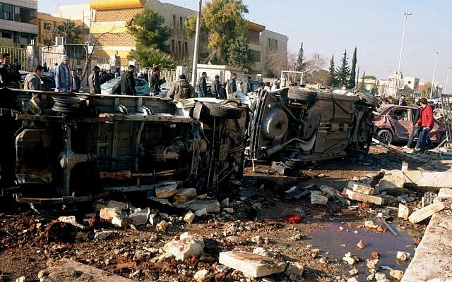 In this photo released by the Syrian official news agency SANA, Syrian people gather at the site after an explosion hit a university in Aleppo, Syria, Tuesday, January 15, 2013 (photo credit: AP/SANA) In this photo released by the Syrian official news agency SANA, Syrian people gather at the site after an explosion hit a university in Aleppo, Syria, Tuesday, January 15, 2013 (photo credit: AP/SANA)