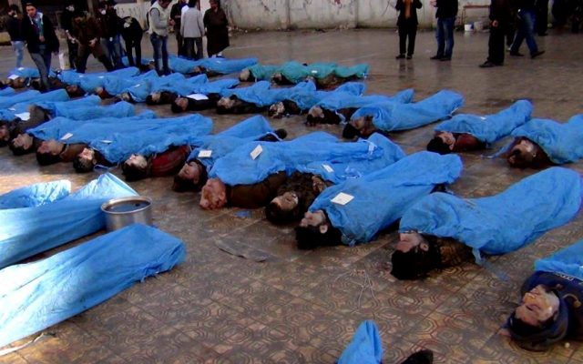 This citizen journalism image shows dead bodies on a street in Aleppo, Syria, Tuesday, January 29, 2013. Syrian activists say at least 65 bodies, some of them with their hands tied behind their back, found on a river bank in the northern city of Aleppo. (photo credit: AP/Aleppo Revolution Against Assad Regime)
