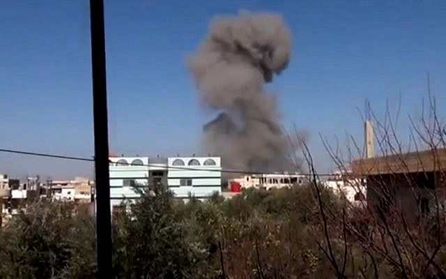 In this image taken from video obtained from the Ugarit News, which has been authenticated based on its contents and other AP reporting, smoke rises after an airstrike hit Daraa, Syria, on Monday, Jan. 14, 2012 (photo credit: Ugarit News via AP video/AP Photo) In this image taken from video obtained from the Ugarit News, which has been authenticated based on its contents and other AP reporting, smoke rises after an airstrike hit Daraa, Syria, on Monday, Jan. 14, 2012 (photo credit: Ugarit News via AP video/AP Photo)