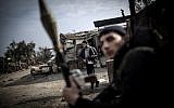 Free Syrian Army fighters hold their weapons during heavy clashes with government forces in Aleppo, Syria, on Sunday, January 20, 2013. (photo credit: AP/Andoni Lubaki)