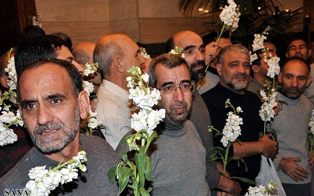 Freed Iranian hostages who were captured by the Syrian rebels since August, after their release in a prisoner swap in Damascus on Wednesday. (photo credit: AP/SANA) Freed Iranian hostages who were captured by the Syrian rebels since August, after their release in a prisoner swap in Damascus on Wednesday. (photo credit: AP/SANA)