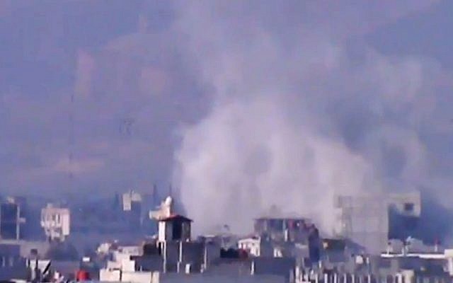 Smoke rises from buildings due to heavy shelling in Damascus countryside, Syria, on Wednesday, January 2, 2013. (photo credit: AP Photo/Shaam News Network via AP video) Smoke rises from buildings due to heavy shelling in Damascus countryside, Syria, on Wednesday, January 2, 2013. (photo credit: AP Photo/Shaam News Network via AP video)