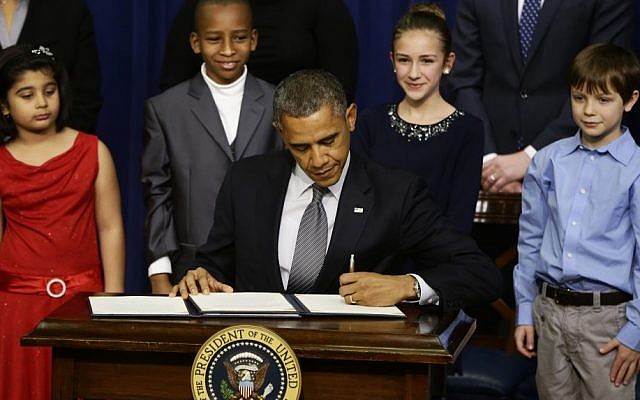 From left to right: Hinna Zeejah, 8, Taejah Goode, 10, Julia Stokes, 11, and Grant Fritz, 8, who wrote letters to President Barack Obama about the school shooting in Newtown, Conn., watch as Obama signs executive orders outlining proposals to reduce gun violence, Wednesday, Jan. 16, 2013, at the White House (photo credit: AP/Charles Dharapak) From left to right: Hinna Zeejah, 8, Taejah Goode, 10, Julia Stokes, 11, and Grant Fritz, 8, who wrote letters to President Barack Obama about the school shooting in Newtown, Conn., watch as Obama signs executive orders outlining proposals to reduce gun violence, Wednesday, Jan. 16, 2013, at the White House (photo credit: AP/Charles Dharapak)
