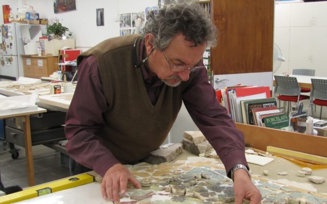 David Bigelajzen, head of the Israel Museum's conservation laboratories, restoring a painting of a tromp l'oeil window from Herodium (photo credit: Andrei Vainer)