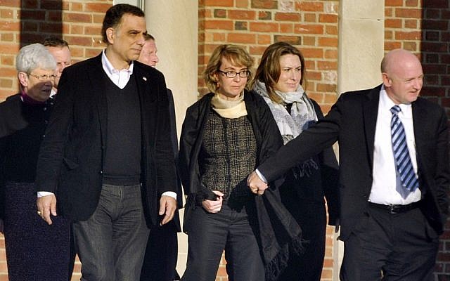Former US Rep. Gabrielle Giffords, center, holds hands with her husband, Mark Kelly, after meeting with officials in Newtown, Conn. on Friday (photo credit: AP/The News-Times/Jason Rearick)