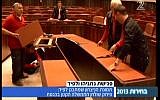 Workers disassemble the cabinet table in the Knesset's plenum (image capture: Channel 2)
