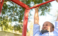 Naftali Bennett, leader of the Jewish Home party, seen doing pull-ups as he visits a religious seminary in Shapiro, as part of his election campaign tour prior to the elections. Or maybe he's preparing for the freshman MK civics boot camp, set to take place Sunday? (photo credit: Yossi Zeliger/Flash90)