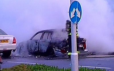 The charred husk of a car that was targeted by a bomb in Tel Aviv  (illustrative photo credit: Channel 2 screenshot)