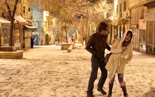 Israelis stroll through the snow covered streets of Jerusalem on Wednesday (photo credit: Nati Shohat/Flash90) Israelis stroll through the snow covered streets of Jerusalem on Wednesday (photo credit: Nati Shohat/Flash90)