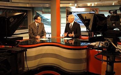 Mitchell Barak, left, founder of Israeli research and political communications firm Keevoon Research, Strategy & Communications, being interviewed on Israel's IBA news (photo credit: courtesy Mitchell Barak)