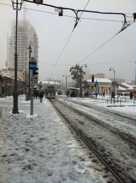 A light rail arrives at the slush-covered Mahane Yehuda stop. (photo credit: Greg Tepper/Times of Israel staff) A light rail arrives at the slush-covered Mahane Yehuda stop. (photo credit: Greg Tepper/Times of Israel staff)