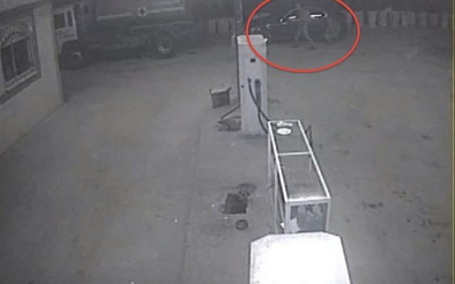 Surveillance camera captures vandals slashing the tires of vehicles at a gas station in the West Bank town of Qabalan (image capture: YouTube)