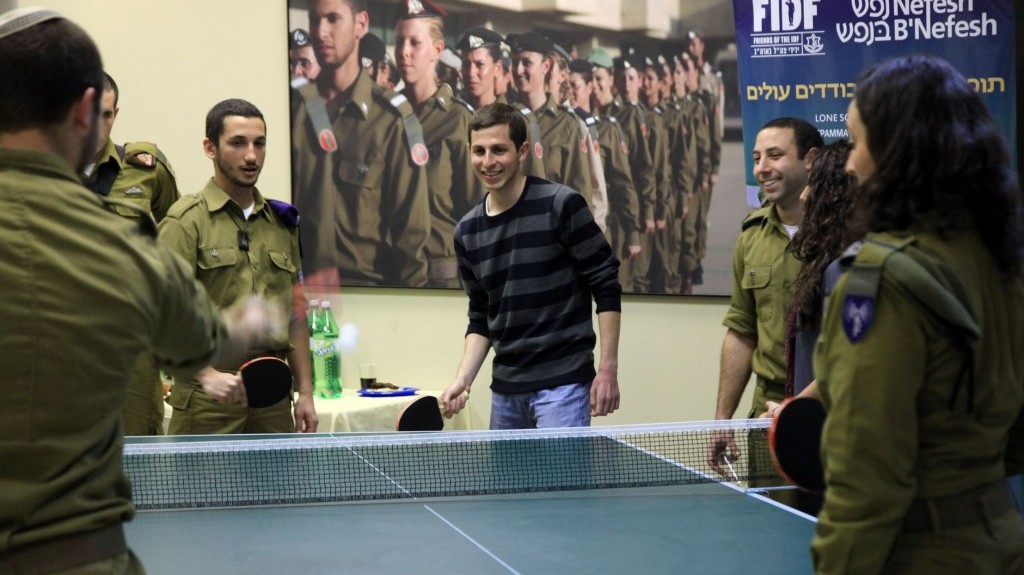 Gilad Shalit plays ping-pong with lone soldiers in the IDF on Thursday (photo credit: Sasson Tiram/Nefesh B’Nefesh)