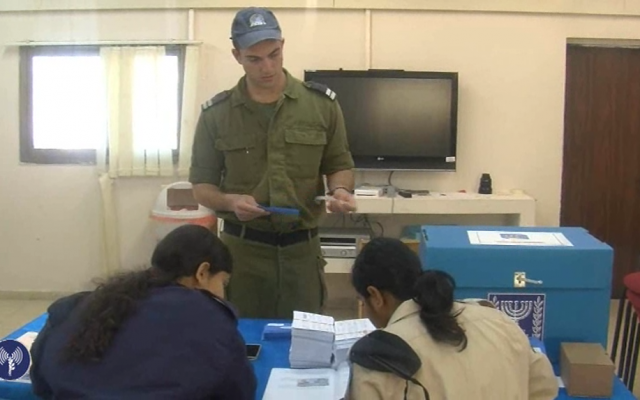 An IDF sailor casts his ballot early on Sunday ahead of Tuesday's parliamentary elections. (photo credit: image capture from IDF Spokesperson video)