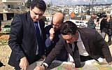 Lawyers for Beit Safafa residents display construction plans at a press conference on Monday, February 18 (Matti Friedman/Times of Israel)