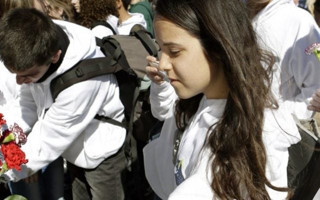 Noa Assa, front, along with fellow students from the Mekif Alef High School in Beersheba place flowers on a gate in front of the Space Mirror Memorial during a remembrance ceremony on the 10th anniversary of the loss of space shuttle Columbia crew at the Kennedy Space Center Visitor Complex, Friday, at Cape Canaveral, Fla. A few hundred people gathered there to remember the Columbia seven, which included the first Israeli spaceman Ilan Ramon. (photo credit: AP Photo/John Raoux) Noa Assa, front, along with fellow students from the Mekif Alef High School in Beersheba place flowers on a gate in front of the Space Mirror Memorial during a remembrance ceremony on the 10th anniversary of the loss of space shuttle Columbia crew at the Kennedy Space Center Visitor Complex, Friday, at Cape Canaveral, Fla. A few hundred people gathered there to remember the Columbia seven, which included the first Israeli spaceman Ilan Ramon. (photo credit: AP Photo/John Raoux)