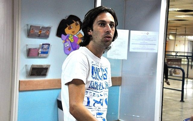 Orel Ben Ari stays late to sort out volunteers, donations, and other day-to-day aspects of running the Tel Aviv Refugee Clinic (photo credit: Michal Shmulovich/Times of Israel)