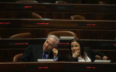 Prime Minister Benjamin Netanyahu and Labor Party leader Shelly Yachimovich speak during a meeting at the Knesset (photo credit: Michal Fattal/Flash90)