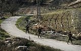 Illustrative photo of IDF soldiers patrolling a field in the West Bank. (Michal Fattal/Flash90)