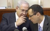 Prime Minister Benjamin Netanyahu, (l) speaks with then-cabinet secretary Zvi Hauser at a weekly cabinet meeting in July 2009. (Ariel Jerozolimski/Flash90/File)