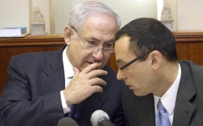 Prime Minister Benjamin Netanyahu, (l) speaks with then-cabinet secretary Zvi Hauser at a weekly cabinet meeting in July 2009. (Ariel Jerozolimski/Flash90/File)