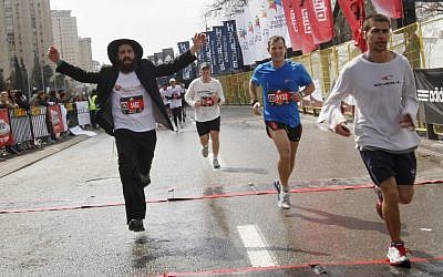 "I'd like to see more ultra Orthodox runners, and more Arab runners," said Rachel Neiman, who regularly runs in Jerusalem. Here, crossing last year's finish line (photo credit: Miriam Alster/Flash 90)