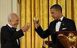 Obama and Peres toasting at the ceremony where Obama presented Peres the Presidential Medal of Freedom in June 2012. (photo credit: Amos Ben Gershom/ GPO/Flash90)