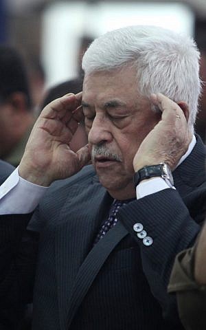 A dismayed Abbas massages his temples during Sunday's press conference (photo credit: Issam Rimawi/Flash90)