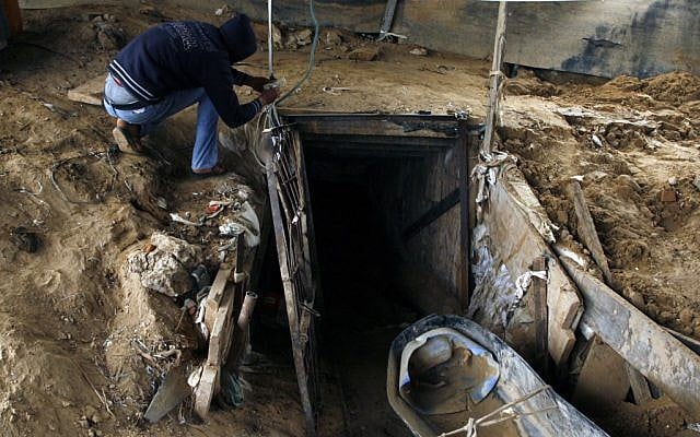 A Palestinian man works outside a smuggling tunnel which connects the Gaza Strip and Egypt in Rafah, southern Gaza Strip on November 24, 2012 (photo credit: Abed Rahim Khatib/Flash90)