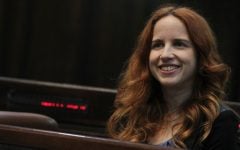 Incoming Knesset member Stav Shaffir of the Labor Party tries out her chair in the plenum, Sunday (photo credit: Miriam Alster/Flash90)