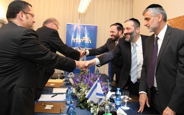 Staying or leaving? Aryeh Deri (with the blue tie) and other Shas leaders meet with Likud to discuss forming a coalition. Deri is reportedly mulling a run for Jerusalem's top office (photo credit: Gideon Markowicz/Flash90)