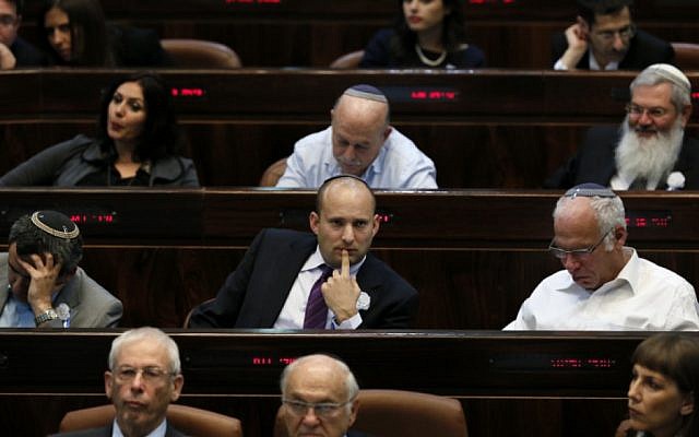 Naftali Bennett (center) seen at the swearing-in ceremony at the opening session of Israel's 19th Knesset, February 5, 2013. (photo credit: Miriam Alster/Flash90)