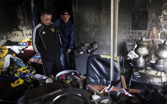 Members of the Beitar Jeursalem soccer club inspect the team's administrative offices after unknown arsonists set it on fire. (photo credit: Flash90) Members of the Beitar Jeursalem soccer club inspect the team's administrative offices after unknown arsonists set it on fire. (photo credit: Flash90)