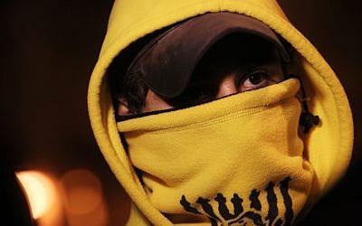 A hooded Beitar Jerusalem fan seen outside the Teddy stadium in Jerusalem ahead of a match on Sunday, February 10 (photo credit: Miriam Alster/Flash90)