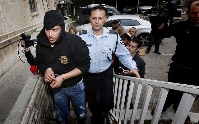 Police bring two suspects arrested for arson at the Beitar Jerusalem football team's office to the Magistrate's Court in Jerusalem on February 19, 2013. (photo credit: Miriam Alster/Flash90) Police bring two suspects arrested for arson at the Beitar Jerusalem football team's office to the Magistrate's Court in Jerusalem on February 19, 2013. (photo credit: Miriam Alster/Flash90)