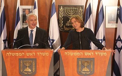 Prime minister Benjamin Netanyahu and Hatnua party leader Tzipi Livni hold a joint press conference to announce Hatnua's joining the coalition on Tuesday, February 19 (photo credit: Miriam Alster/Flash90)