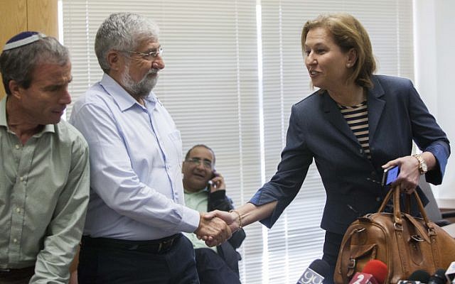 Tzipi Livni shakes hands with Amram Mitzna during a Hatnua party meeting at the Knesset on February 20, 2013. (photo credit: Yonatan Sindel/Flash90)