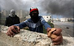 Palestinian protesters clash with Israeli security forces in the West Bank, Friday; the violence continued on Saturday, with one Palestinian demonstrator reportedly wounded near Nablus. (photo credit: Issam Rimawi/Flash90)
