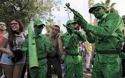 Israelis wearing costumes pose for a photo during a Purim street party in Tel Aviv. (photo credit: Tsafrir Aboav/Flash90)