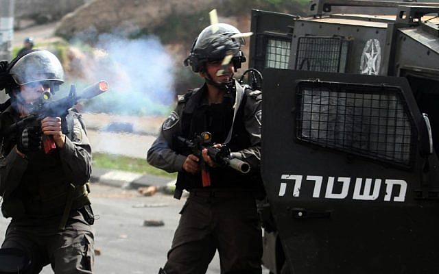 An Israeli border policeman fires rubber bullets at stone-throwing Palestinian protesters during clashes outside Israel's Ofer military prison near the West Bank city of Ramallah, February 24, 2013 (photo credit: Issam Rimawi/Flash90) An Israeli border policeman fires rubber bullets at stone-throwing Palestinian protesters during clashes outside Israel's Ofer military prison near the West Bank city of Ramallah, February 24, 2013 (photo credit: Issam Rimawi/Flash90)