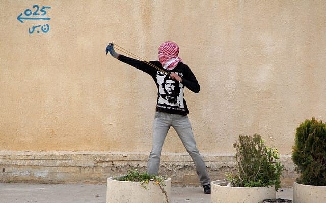 A protester slinging stones near Ramallah Monday. (photo credit:  Issam Rimawi/Flash90)