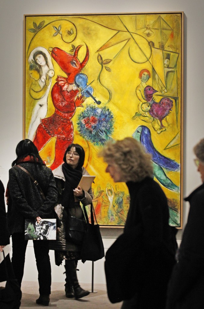 Members of the media stand in front of: La Danse, a 1952 painting by Russian artist Marc Chagall before the opening of the exhibition: Chagall, between War and Peace, at the Luxembourg museum in Paris, Tuesday Feb. 19, 2013. The exhibition starts February 21 and ends July 21, 2013. (photo credit: AP/Remy de la Mauviniere)