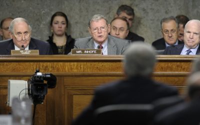 Senate Armed Services Committee ranking member Sen. James Inhofe, R-Okla., center , asks a question of former Nebraska Sen. Chuck Hagel, in foreground, during the Senate Armed Services Committee hearing on his nomination on Thursday. Senate Armed Services Committee Chairman Carl Levin, D-Mich., left, and Sen. John McCain, R-Ariz., right, listen. (photo credit: AP/Susan Walsh)