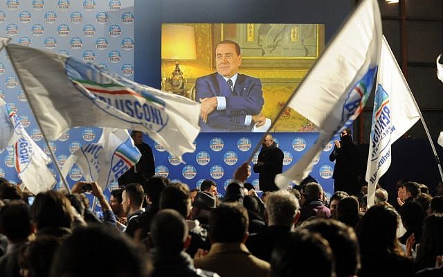 Supporters wave flags in front of a giant monitor broadcasting a message by Silvio Berlusconi during a center-right coalition rally in Naples, Italy, Friday, Feb. 22, 2013 (photo credit: AP/Salvatore Laporta) Supporters wave flags in front of a giant monitor broadcasting a message by Silvio Berlusconi during a center-right coalition rally in Naples, Italy, Friday, Feb. 22, 2013 (photo credit: AP/Salvatore Laporta)