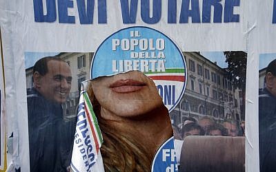 A torn electoral poster shows center-right coalition leader Silvio Berlusconi in Rome, Monday, Feb. 25, 2013. Italy's crucial elections appear to be heading toward gridlock, initial results show, with the center-left forces of Pier Luigi Bersani headed toward victory in the lower house of Parliament and the camp of former premier Silvio Berlusconi gaining the upper hand in the equally powerful Senate. (photo credit: AP/Gregorio Borgia)