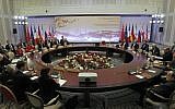 Diplomats participate in the fourth round of high-level talks with an Iranian delegation, right, aimed at stopping the Islamic regime's nuclear program from making atomic weapons in Almaty, Kazakhstan in February. (photo credit: AP/ Shamil Zhumatov, Pool)